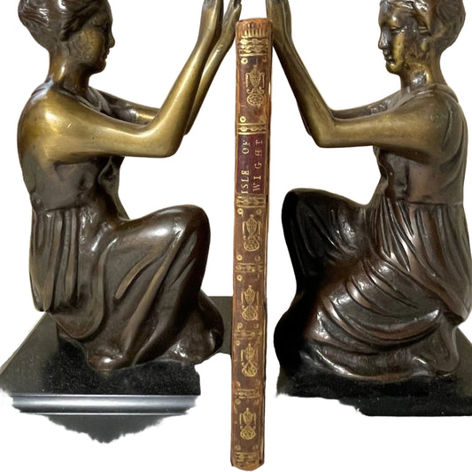 Narrow gilt-decorated brown spine of A View of the Isle of Wight between figurative bookends.