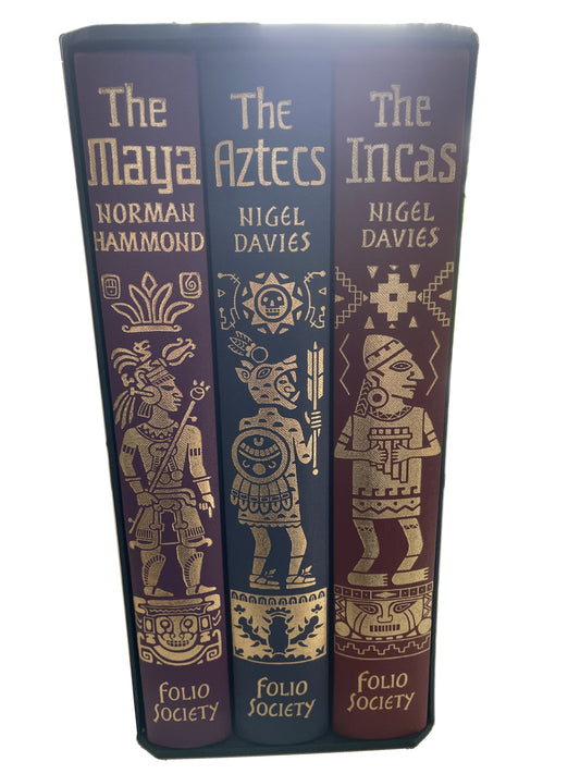 Spines of The Maya, The Aztecs and The Incas in their slipcase, with gold titles and illustrated figures on purple, blue and reddish-brown cloth.