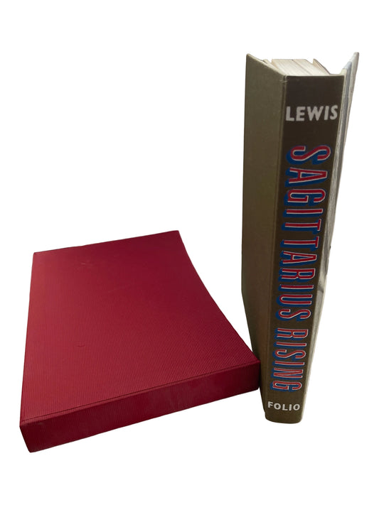 Sagittarius Rising standing beside its red slipcase, showing the lettered spine and exposed top page edges.