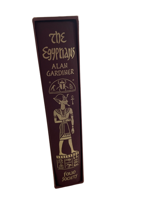 Burgundy spine of The Egyptians by Alan Gardiner in its slipcase, with gold title lettering, an Egyptian figure and the Folio Society imprint.