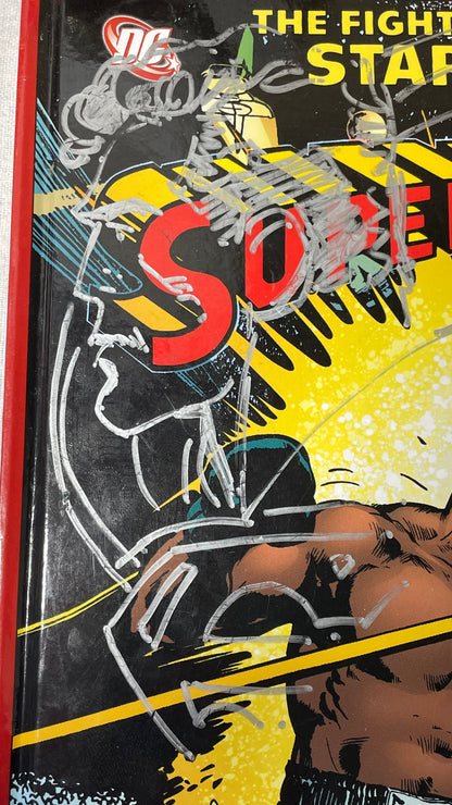 Silver-marker Superman drawing on the illustrated cover of Superman vs. Muhammad Ali.