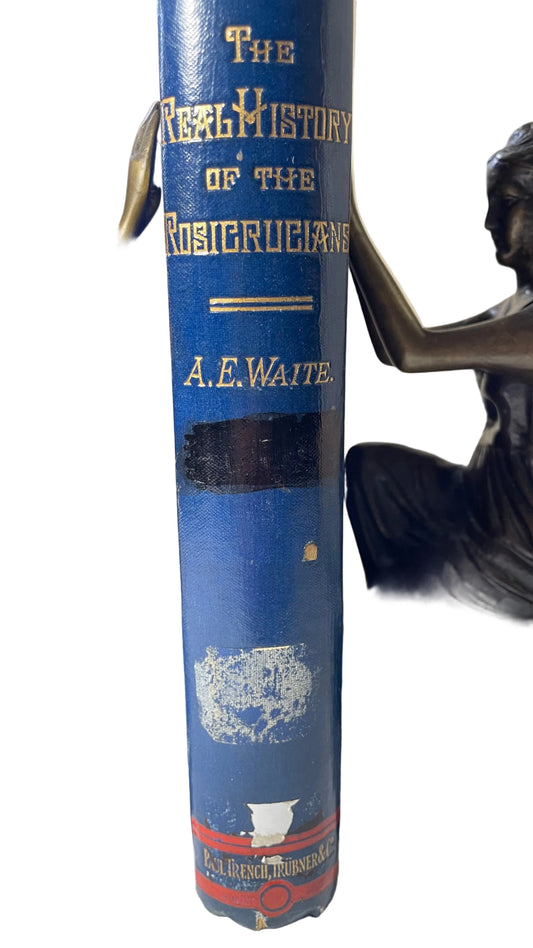 Gilt-lettered blue spine of A. E. Waite's The Real History of the Rosicrucians, with old label remnants.