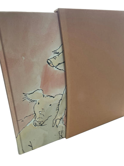 Animal Farm standing upright beside its orange-brown slipcase, with part of the illustrated pig cover visible.