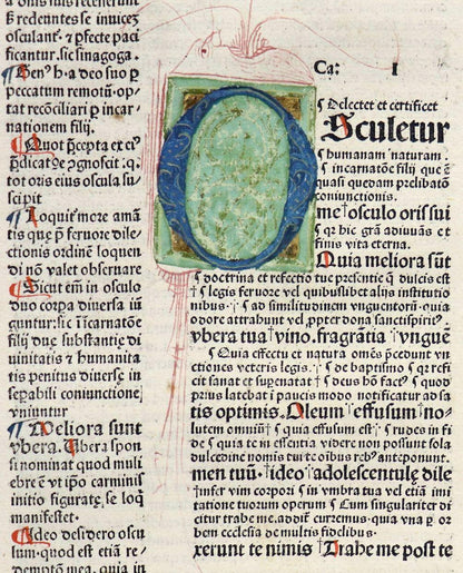 Close-up of Biblia Latina with the Glossa Ordinaria (c. 1480), showing a blue-and-green initial, black text and red flourishes.