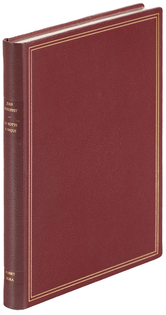 Angled view of Jean Dubuffet's La Botte à Nique (1973), showing a burgundy cover, double gold-colored border and titled spine.
