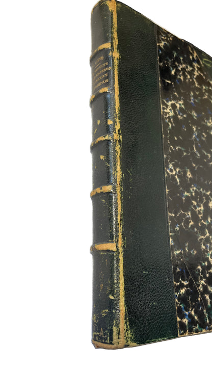 Angled detail of the worn green spine and marbled cover of Thoughts of the Emperor Marcus Aurelius Antoninus.