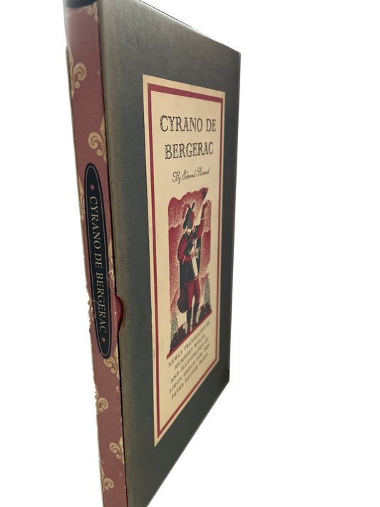 Angled view of Cyrano de Bergerac in its slipcase, showing the patterned red spine, title label and worn edges.