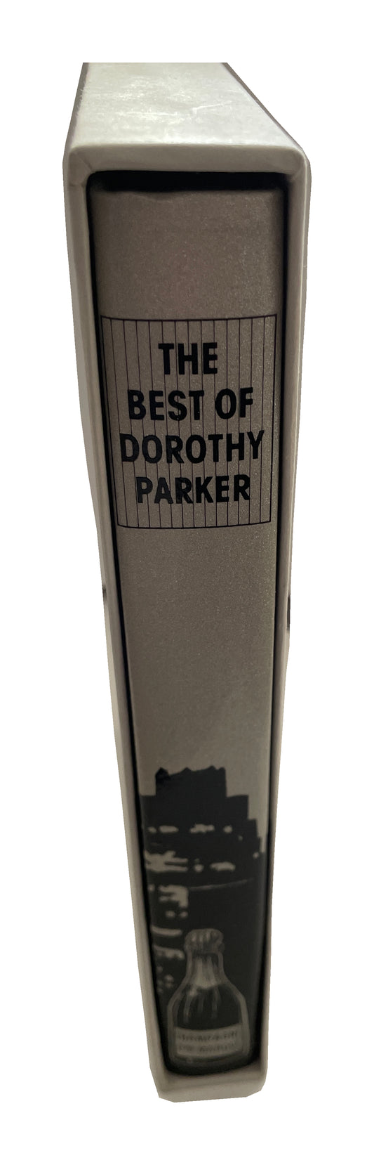 Gray spine of The Best of Dorothy Parker in its light-colored slipcase, with black title lettering, a city silhouette and a champagne-bottle illustration.