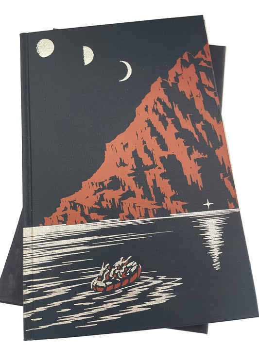 Illustrated cover of Ill Met by Moonlight, showing three moon phases, reddish cliffs and a boat on water, with the slipcase beneath.
