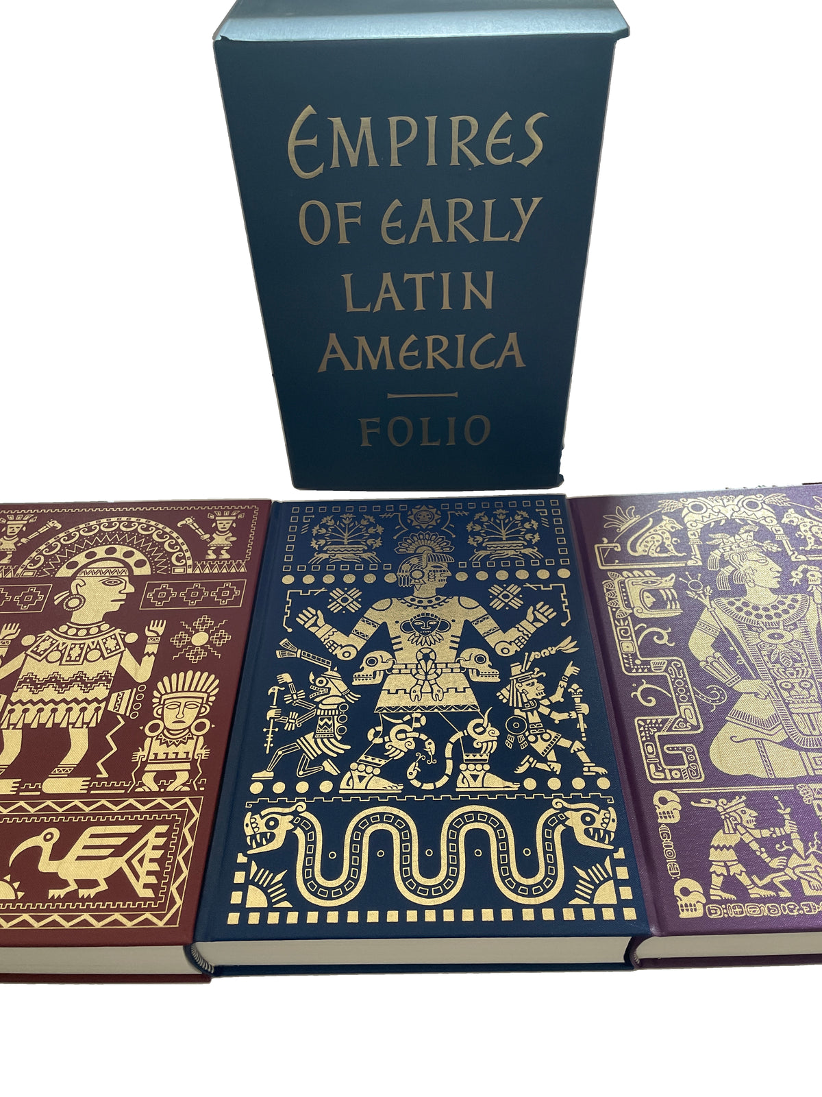 Three gold-illustrated cloth covers from Empires of Early Latin America laid side by side in front of the dark title-lettered slipcase.