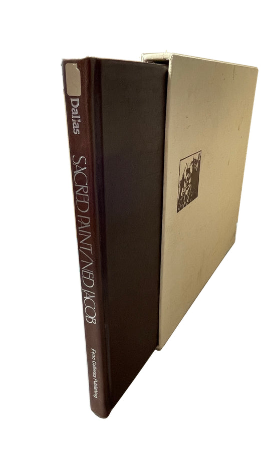 Brown Sacred Paint volume partly out of its pale cloth slipcase, with white spine lettering, an old pale label and visible cloth wear.
