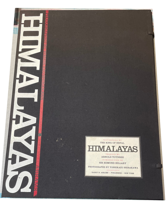 Black Himalayas case with vertical white title, red stripe and a label crediting Yoshikazu Shirakawa.